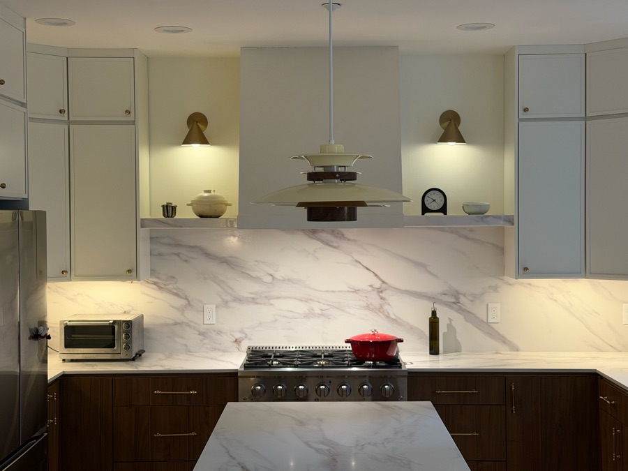 Charlene's remodeled kitchen: marble backsplash, walnut cabinets and brass wall lights